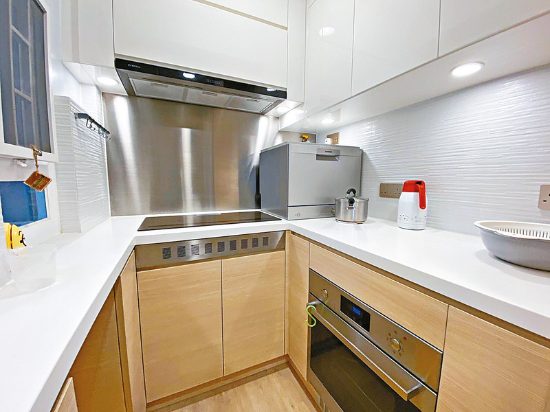 ■廚房設有多組木系廚櫃，顯得簡潔。