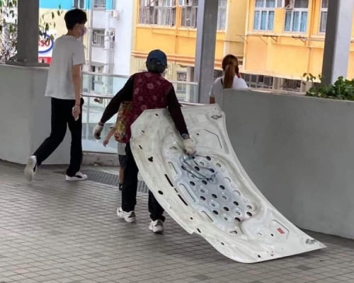 一名婦人拖着一大塊汽車鋼板照片在網上流傳。網圖