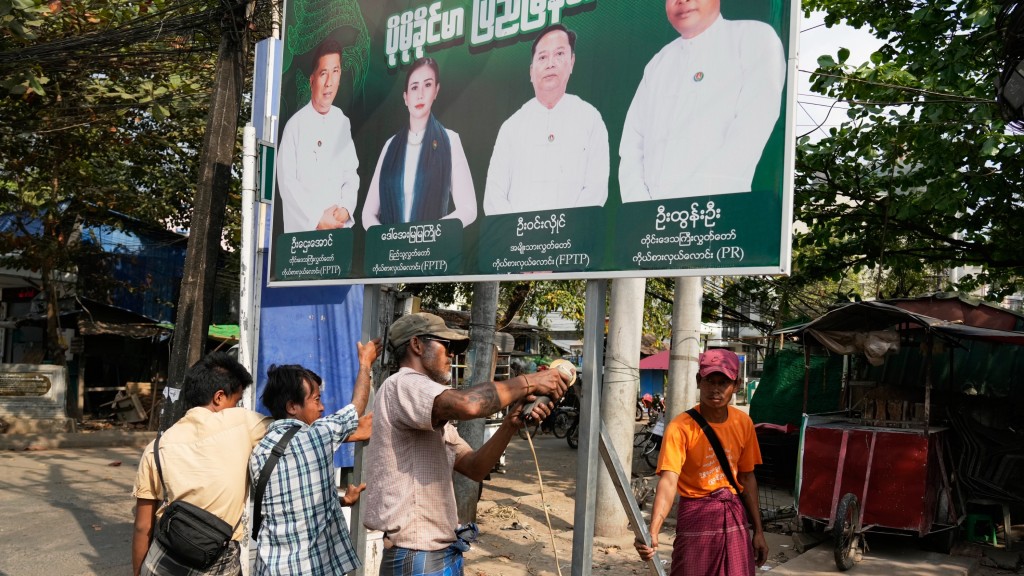 緬甸鞏發黨支持者在最後一輪投票前夕移除宣布海報。 美聯社