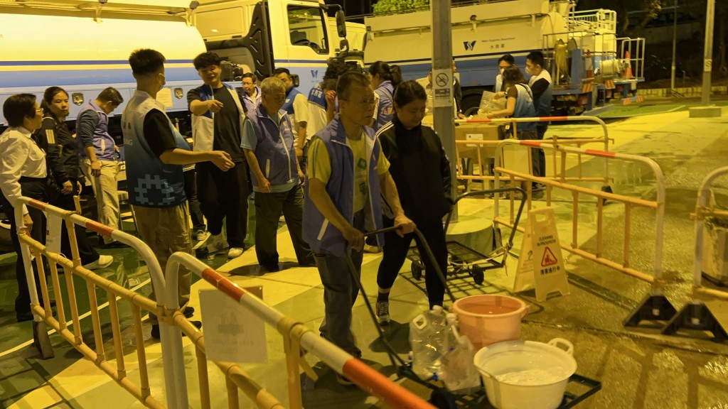 受影響居民到樓下取水。