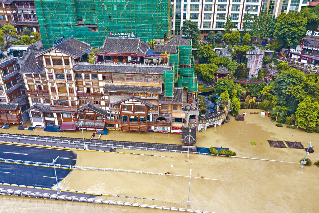 重慶洪崖洞景區臨江公路和房屋被洪水淹沒。　