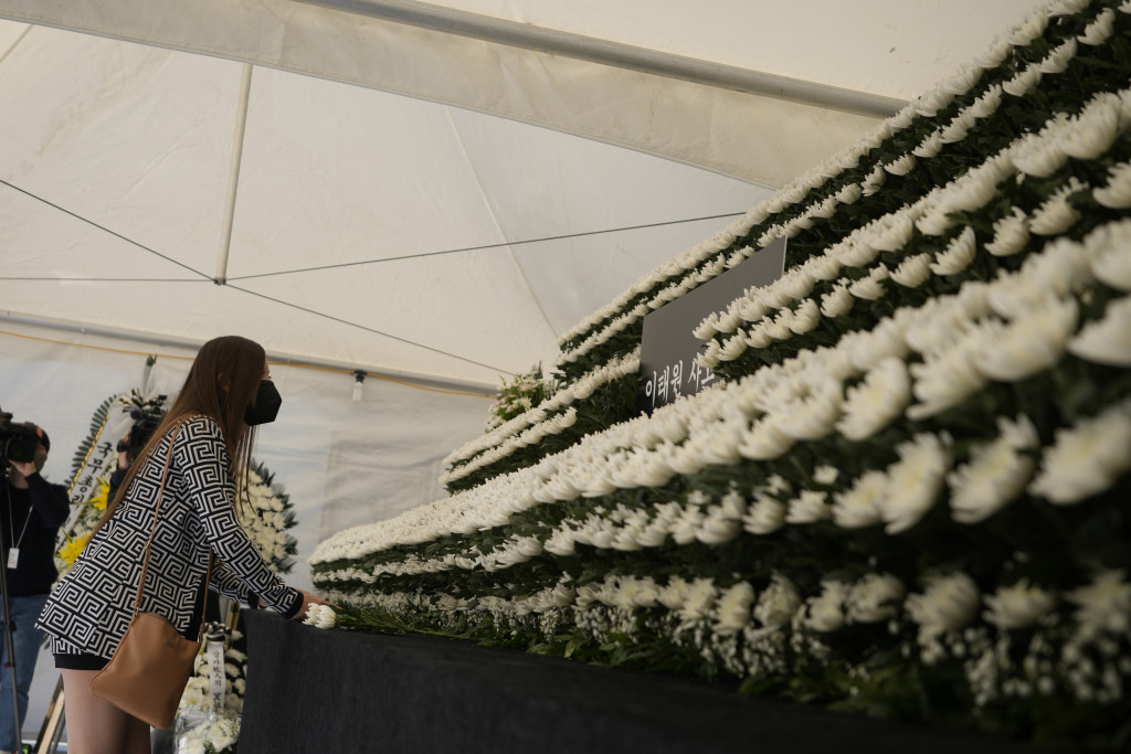 一名哀悼者在首尔一个联合纪念坛上献花，向事故罹难者致敬。AP