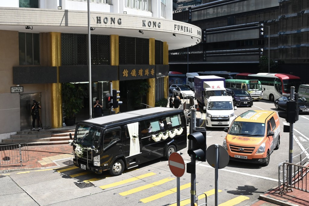 靈車離開北角香港殯儀館後,靈柩移送跑馬地香港墳場,胡鴻烈與其亡妻、仁大創校校長鍾期榮合葬。(圖片來源:中新社) 靈車離開北角香港殯儀館後,靈柩移送跑馬地香港墳場,胡鴻烈與其亡妻、仁大創校校長鍾期榮合葬。(圖片來源:中新社)