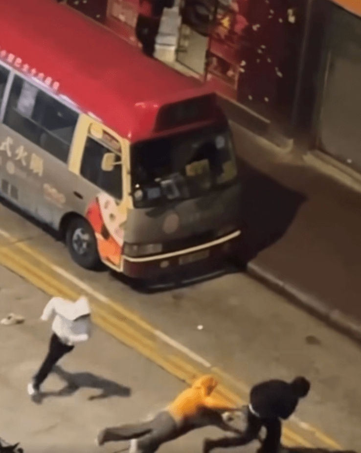 黑衣男子趁勢想搶走事主的斜孭袋,但事主死命抓緊不放,雙方在馬路上拉扯角力。fb「車cam L(香港群組)」 黑衣男子趁勢想搶走事主的斜孭袋,但事主死命抓緊不放,雙方在馬路上拉扯角力。fb「車cam L(香港群組)」