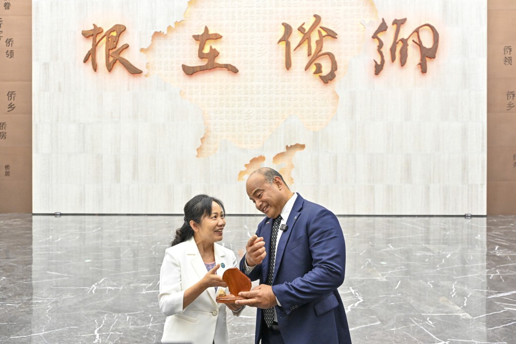 阿迪昂(右)贈送以瑙魯地圖為主題的紀念品予廣東江門的中國僑都華僑華人博物館。 中新社 阿迪昂(右)贈送以瑙魯地圖為主題的紀念品予廣東江門的中國僑都華僑華人博物館。 中新社