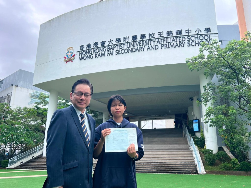 香港浸會大學附屬學校王錦輝中小學女狀元劉子湉（右）、陳偉佳校長（左）。校方提供