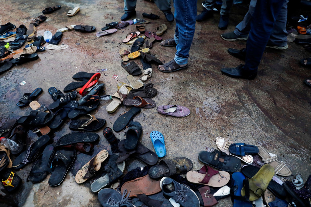巴基斯坦卡拉奇齋戒月搶食物致人踩人，事故過後留下滿地鞋子。 路透社