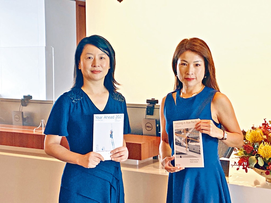 ■胡一帆（左）預計，明年仍存不確定性，但若次季疫苗開始廣泛採用，相信本港經濟會反彈。