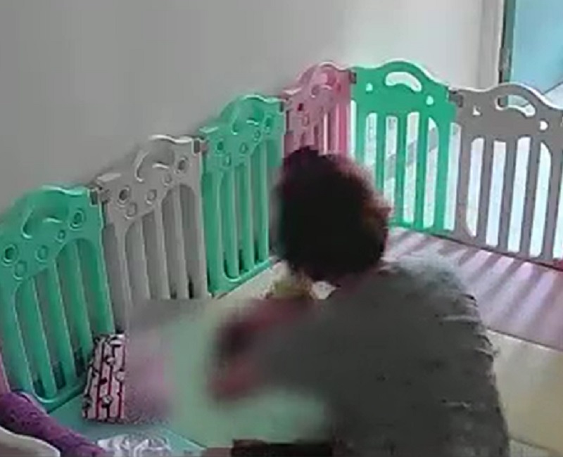 一名女子粗暴對待嬰兒。影片截圖