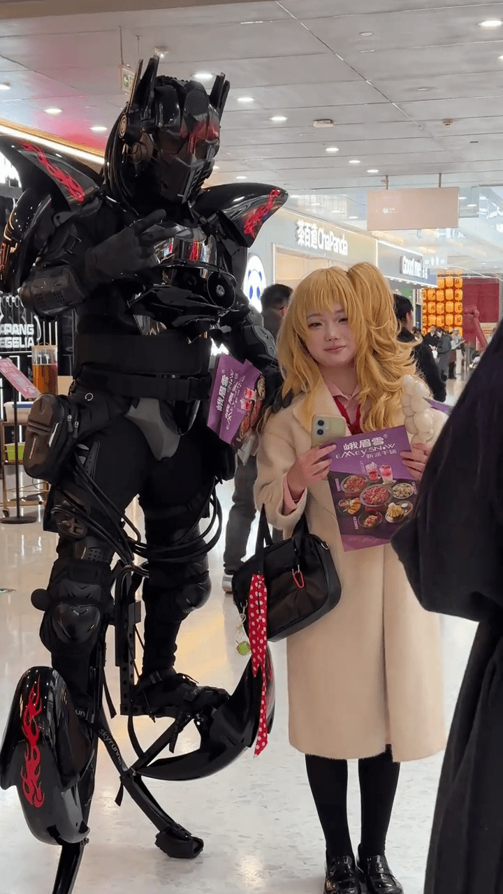 周高賽穿上機甲「戰衣」與民眾合照，令他倍感自豪。 抖音