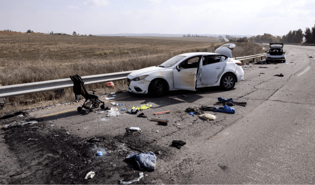 10 月 10 日，在以色列南部卡法 阿扎基布茲附近的道路上，一輛汽車旁出現了包括兒童嬰兒車在內的個人物品。路透社