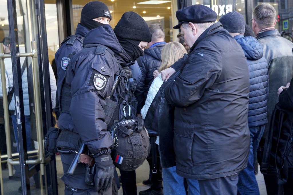圣彼得堡有防暴警察查看一个摇滚音乐会观众的随身物件。美联社