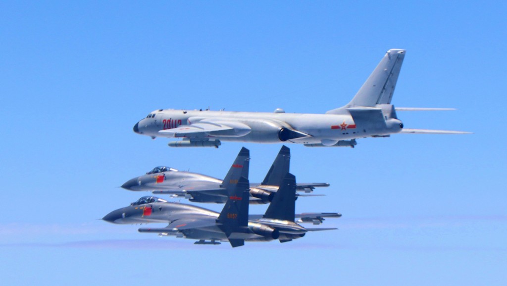 南部戰區的空軍殲-11戰機與轟-6K戰機編隊飛行。 新華社示意圖
