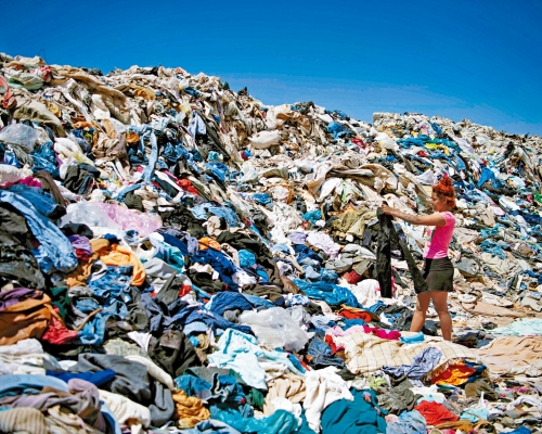 婦女在智利沙漠的舊衣堆中，尋找可重用的衣物。