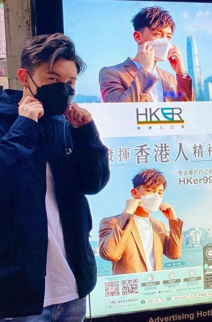 张天赋(MC)喺巴士站宣传灯箱影相留念。