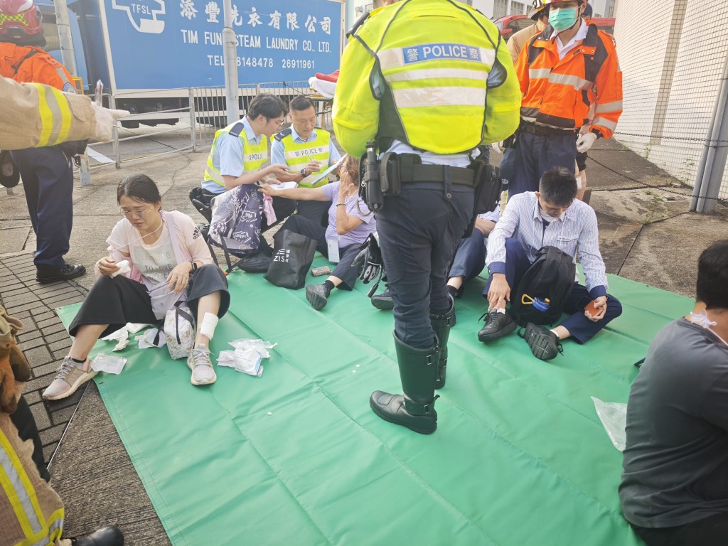 多名巴士乘客受傷,由救護員進行治理。 多名巴士乘客受傷,由救護員進行治理。