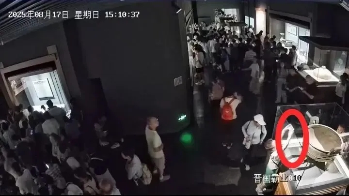 閉路電視畫面可見,一名小童舉起手機在展櫃邊緣拍攝。 閉路電視畫面可見,一名小童舉起手機在展櫃邊緣拍攝。