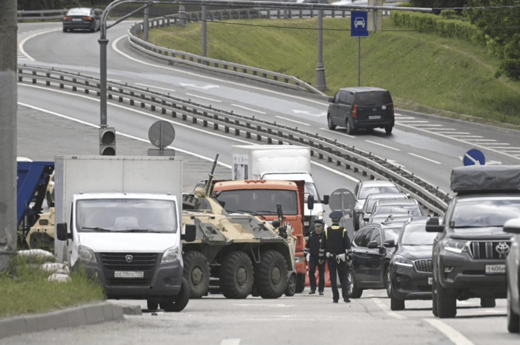 6 月 24 日星期六，一辆装甲运兵车和警车泊在驶向俄罗斯莫斯科的高速公路入口，气氛紧张。美联社图片