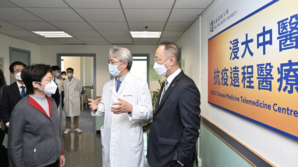 行政長官林鄭月娥（左一）聽取浸大校長衞炳江（右一）及協理副校長（中醫藥發展）兼中醫藥學院臨床部主任卞兆祥（右二）介紹中心服務。政府新聞處
