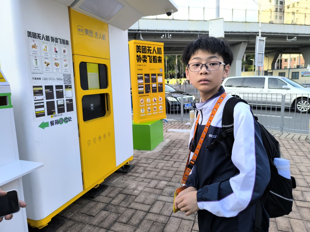  跨境返学的中一生高同学表示，下午放学后经福田口岸返屋企，无意中见到口岸广场柱立的美团无人机快递柜，觉得很新奇，日后会尝试在此订外卖。 黄少君摄