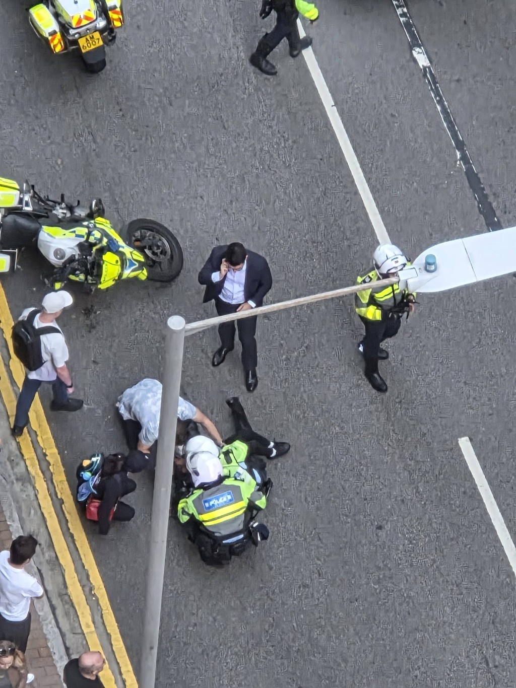 男童受傷倒地，警員及途人在旁協助。fb 車cam L（香港群組）  
