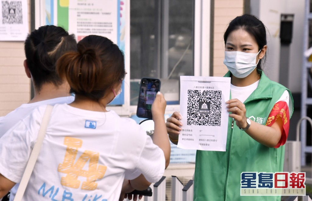 北京朝阳区十里堡社区市民出入要进行健康码查验。新华社