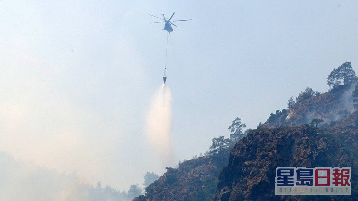 直升機在火場投擲水彈以控制火勢。路透社圖片