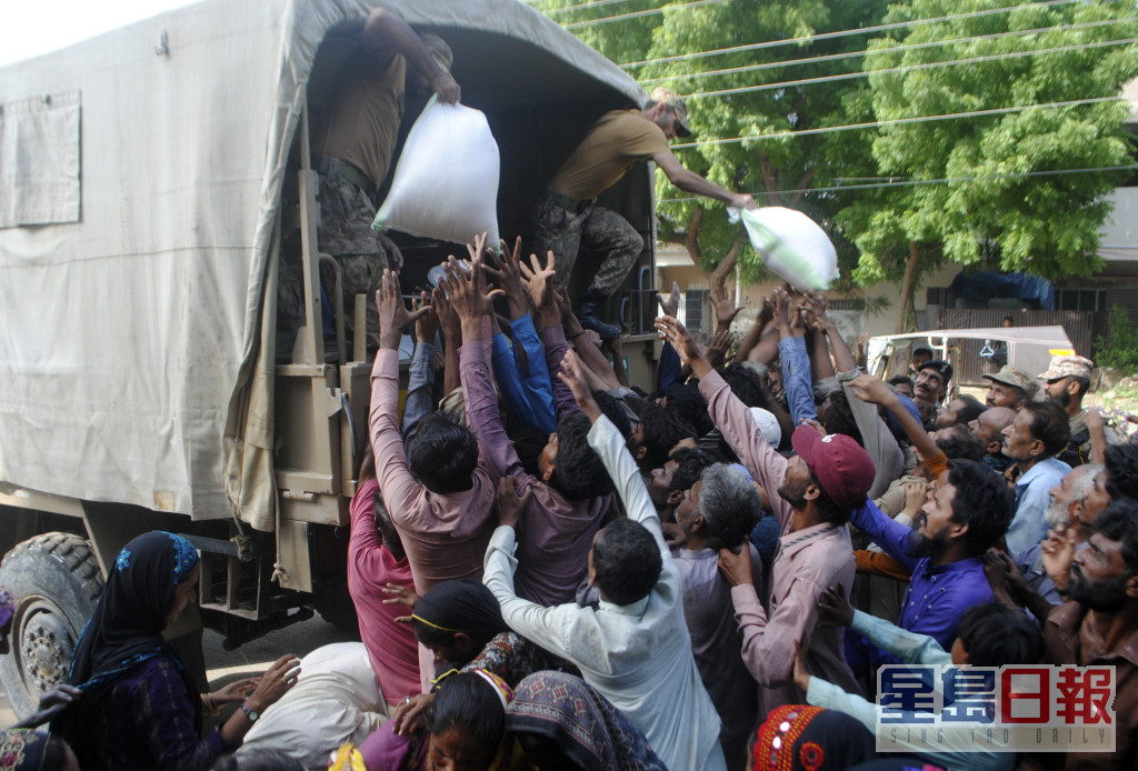 军队向流离失所的居民分发食物和用品。AP