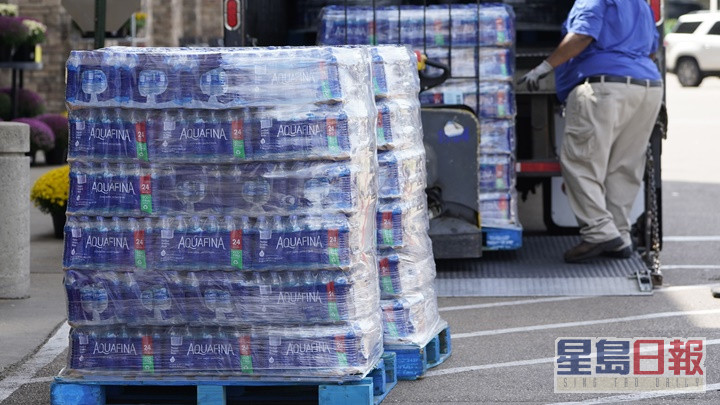 当地政府呼吁下，民众改以樽装水代替自来水。AP图片
