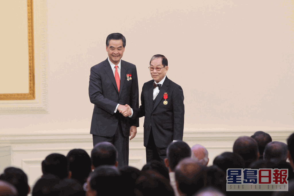 杨润雄指顾嘉辉（右）先后在1988年和2015年，获颁授铜紫荆星章和金紫荆星章。资料图片