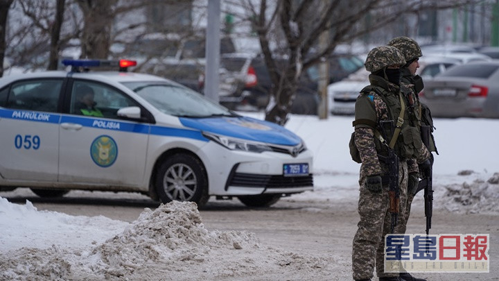 哈薩克軍警在街頭擎槍戒備。AP圖片