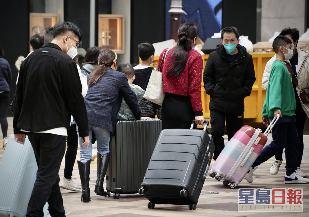 有游客推着行李箧在广东道一带逛商店。苏正谦摄