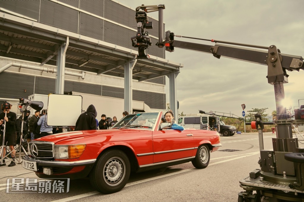 拍攝時她一邊唱着節奏輕快的新歌，一邊遊車河。