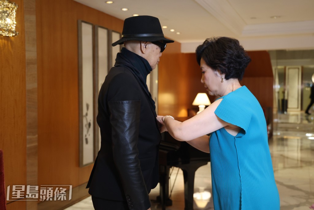 阿姐在訪問空檔時細心為家英哥整理服裝，兩公婆感情非常好。