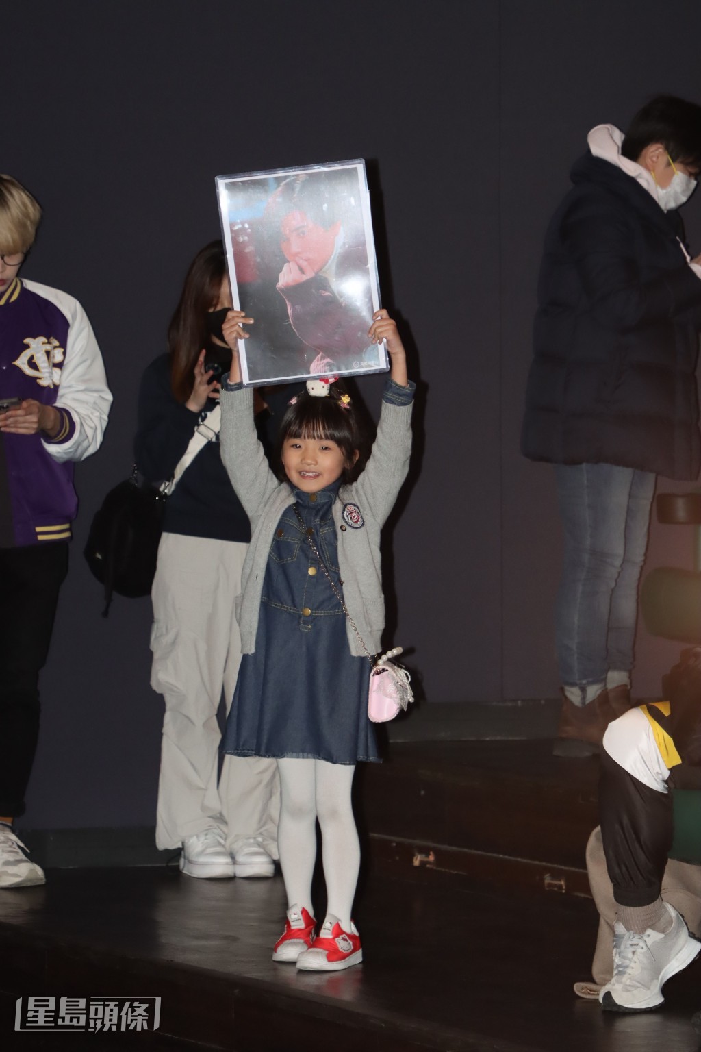 这位7岁的小妹妹也高举了照片，希望引起城城关注。