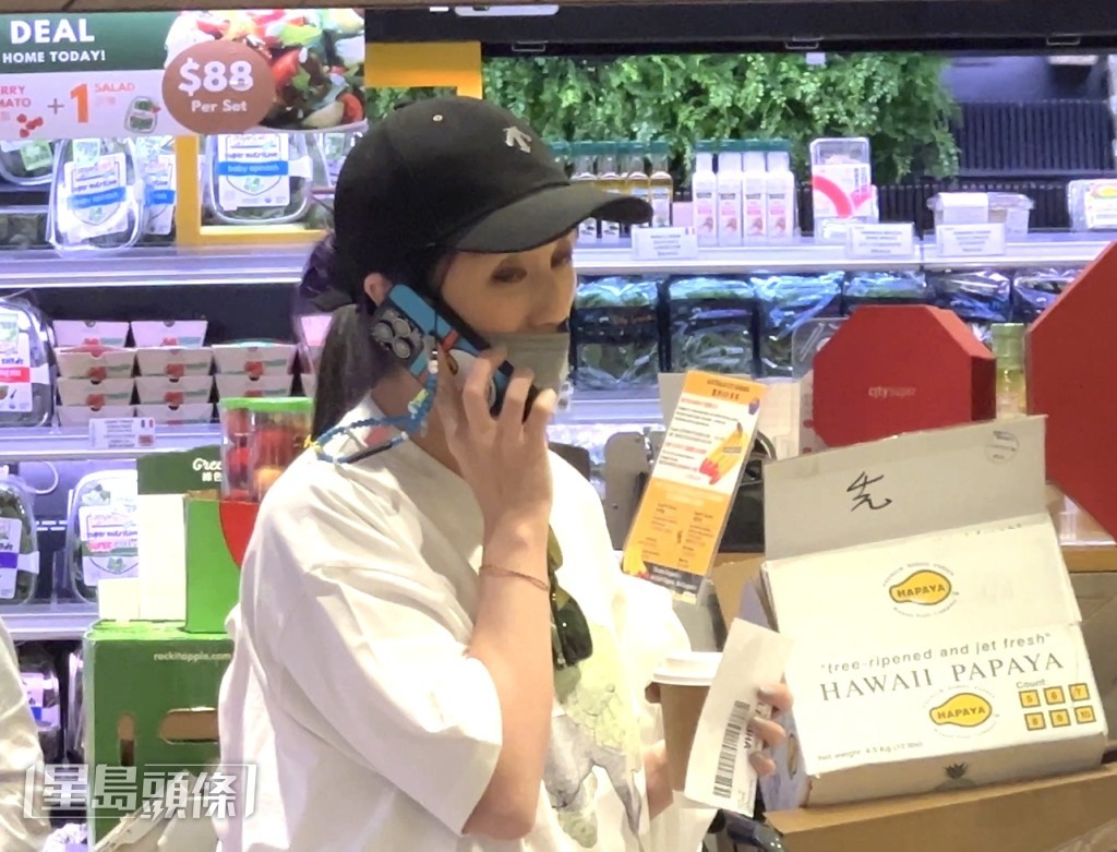 千嬅一邊傾電話一邊揀食物，非常忙碌。