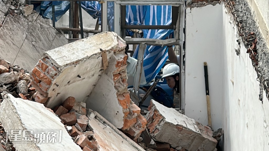 石屎墙倒塌砖头堕下压住工人下半身。梁国峰摄