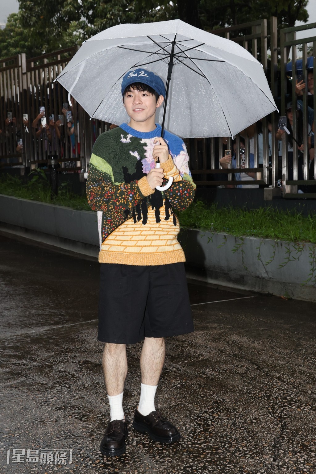 Hellosss無懼大雨堅守電台門外。 Hellosss無懼大雨堅守電台門外。