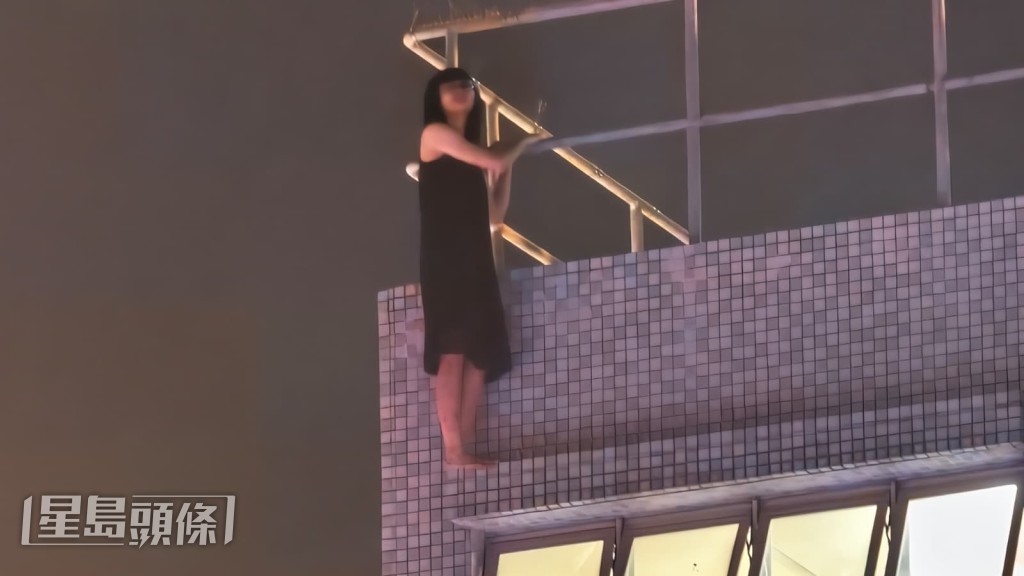 一名身穿黑色長裙、赤腳的女子,被發現於元州邨元謙樓旁一平台危站在狹窄簷篷上。黎志偉攝 一名身穿黑色長裙、赤腳的女子,被發現於元州邨元謙樓旁一平台危站在狹窄簷篷上。黎志偉攝
