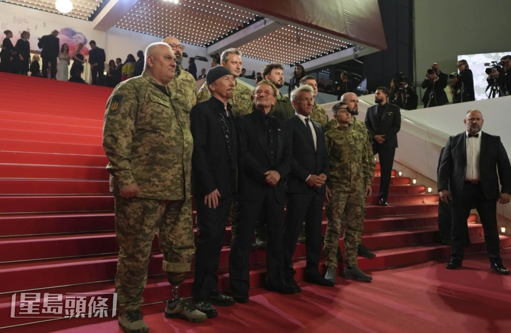 Bono(前排中)出席其紀錄片康城首映,獲好友The Edge和辛潘(Bono身旁)及一眾軍人撐場。(美聯社) Bono(前排中)出席其紀錄片康城首映,獲好友The Edge和辛潘(Bono身旁)及一眾軍人撐場。(美聯社)
