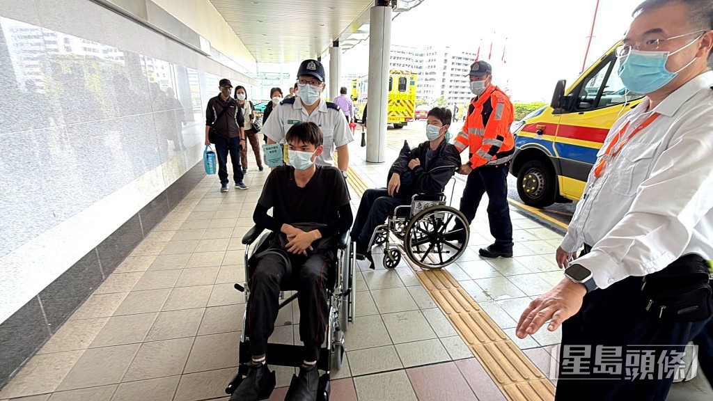 兩名傷者坐輪椅送院。 兩名傷者坐輪椅送院。