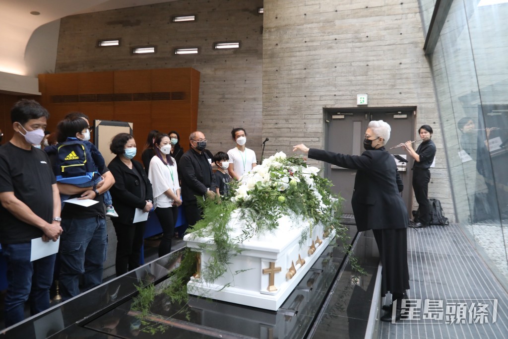 遺孀陳敏兒向廖啟智的靈柩獻花。