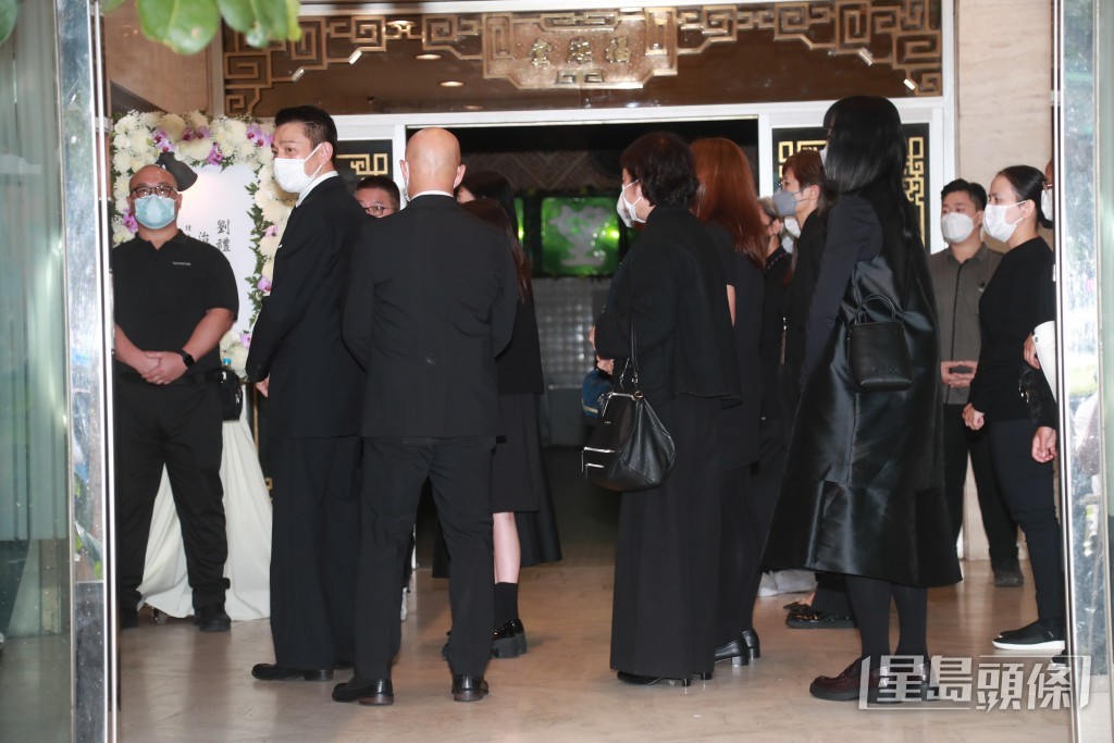 劉德華背着殯儀館內的傳媒，似刻意用人牆包圍着女兒及太太盡量避開傳媒鏡頭。