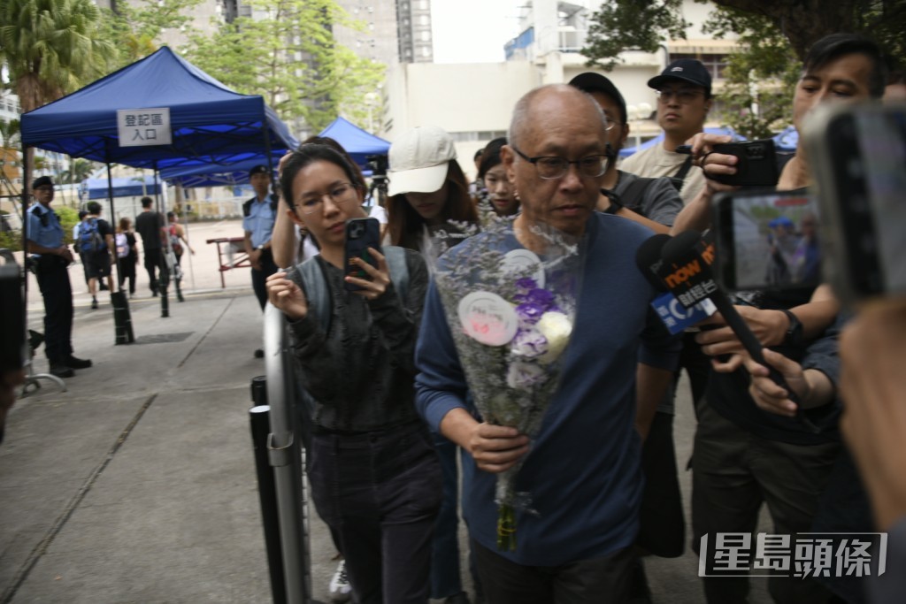葉先生手持鮮花上樓悼念亡妻。楊偉亨攝