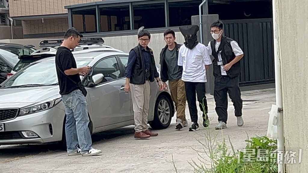 鄭雋熹被黑布蒙頭,由探員押返南坑村調查。蔡楚輝攝 鄭雋熹被黑布蒙頭,由探員押返南坑村調查。蔡楚輝攝