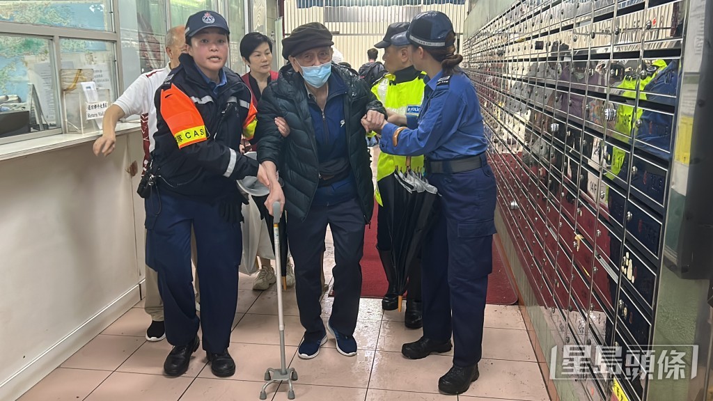 消防及民安隊協助年紀老邁的居民返回住所。林思明攝 消防及民安隊協助年紀老邁的居民返回住所。林思明攝