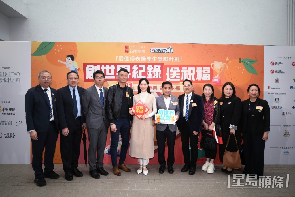活动司仪冯盈盈（持福字者）与来自不同学校的校长代表合照。