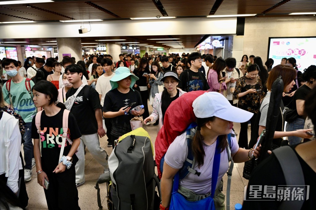 不少過關旅客準備入閘港鐵。 不少過關旅客準備入閘港鐵。