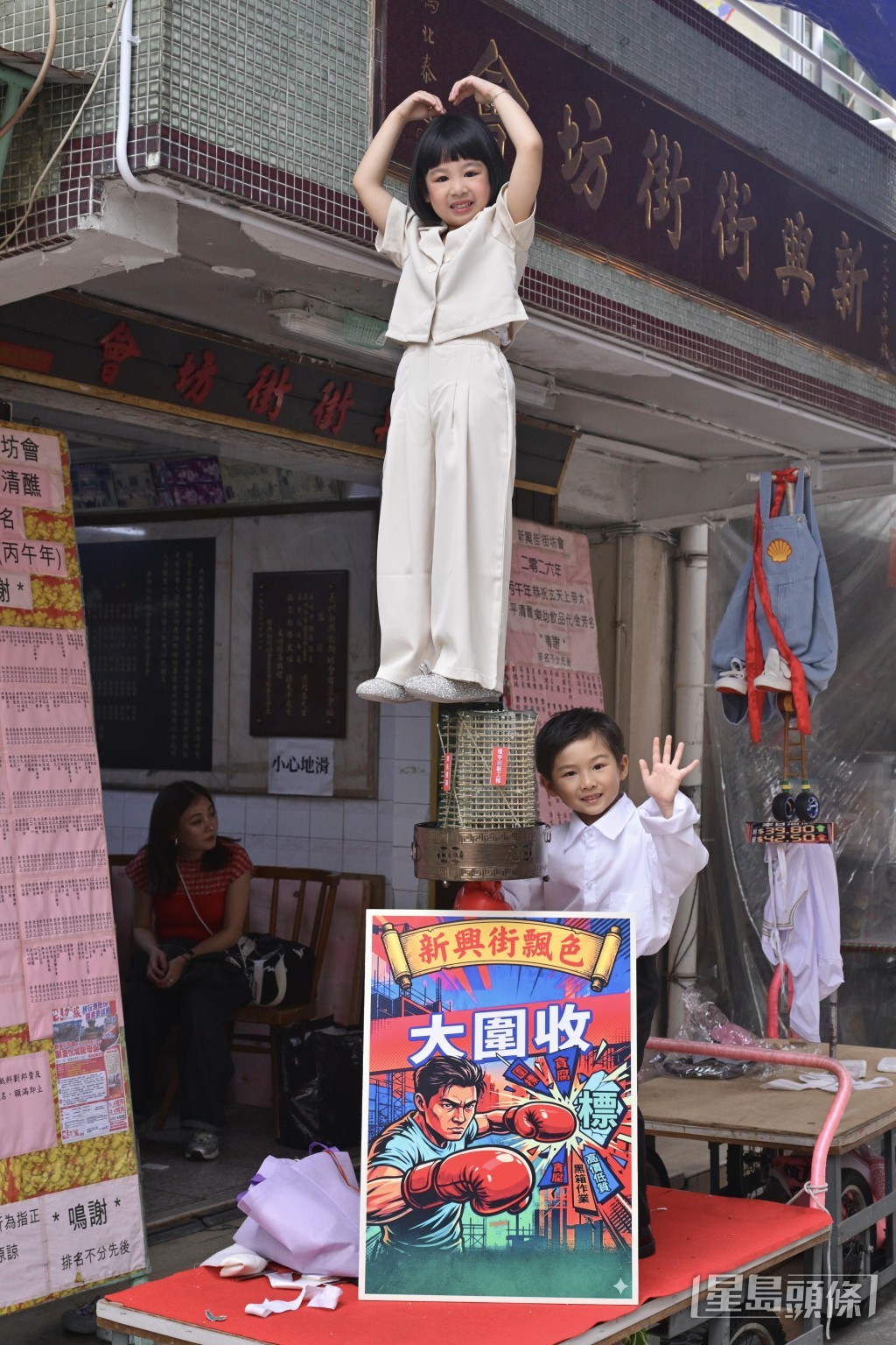 作為色芯「小前輩」的5歲冬冬(上)和4歲半梓航(右二),在「大圍收」的飄色台上扮演政府官員。 作為色芯「小前輩」的5歲冬冬(上)和4歲半梓航(右二),在「大圍收」的飄色台上扮演政府官員。