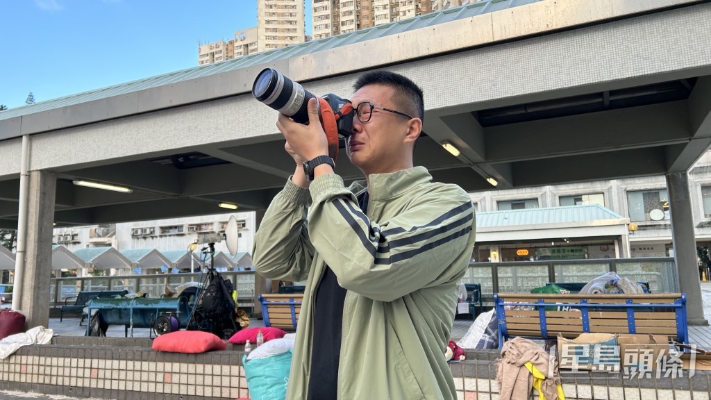 陸先生借用記者長鏡遙望被燒毀的家園，不禁悽然下淚。蔡楚輝攝